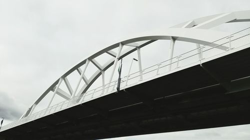 Low angle view of suspension bridge against sky