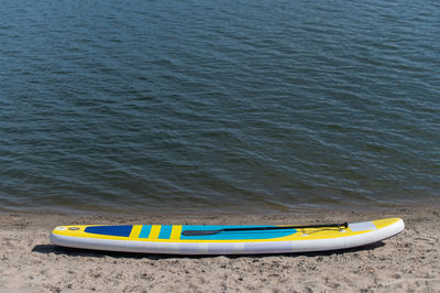 High angle view of yellow moored on beach