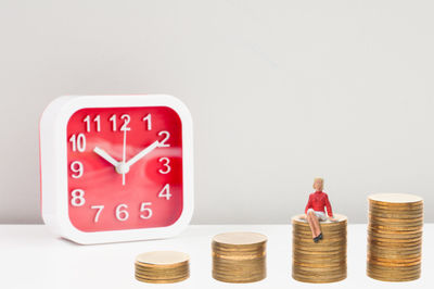 Close-up of clock on table against white background