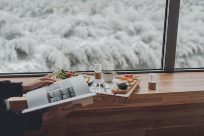 Coffee cup on table against window