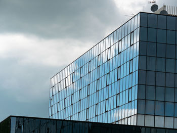 Blue sky and clouds reflected in the glass building