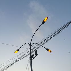 Low angle view of yellow balloons against sky