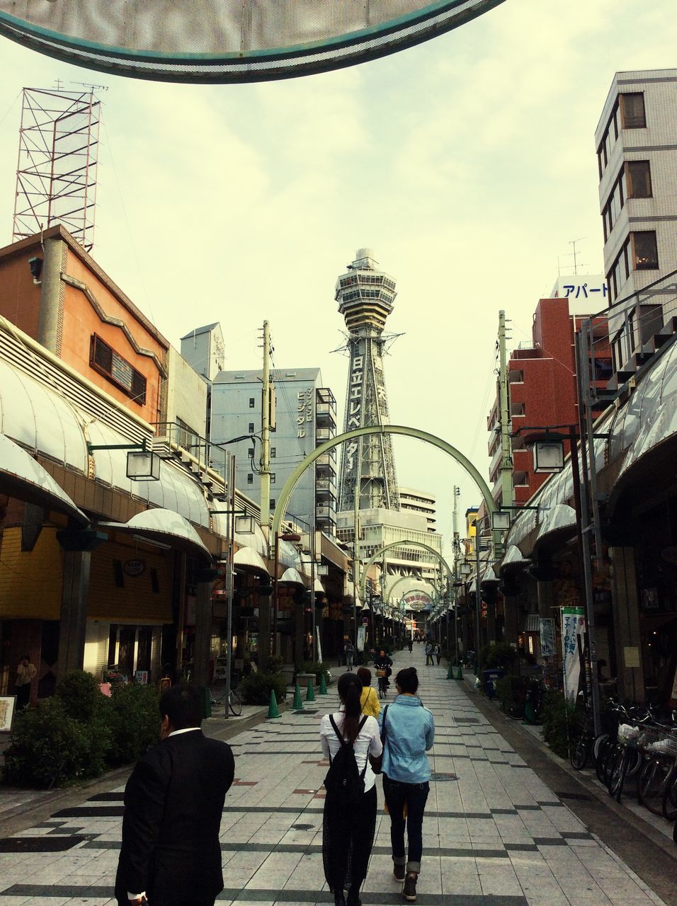 building exterior, architecture, built structure, city, men, walking, lifestyles, city life, person, street, rear view, sky, leisure activity, full length, building, incidental people, residential building, city street, tower