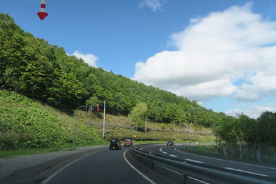 Cars on road against sky