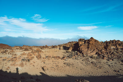 Rock formations in desert against blue sky