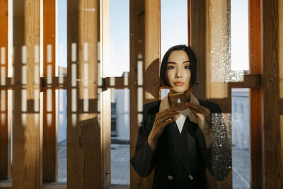 Beautiful woman looking through window