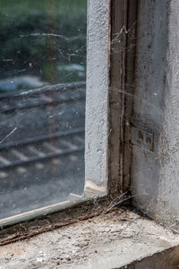 Close-up of wet window of old building