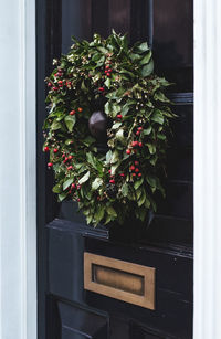 Close-up of wreath on black door