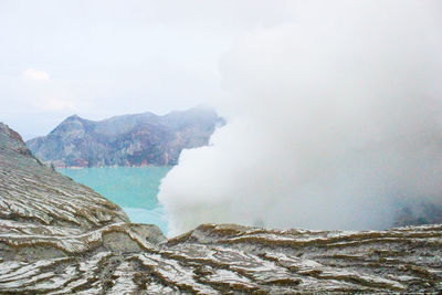 Scenic view of volcanic mountain against sky