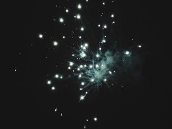 Low angle view of firework display at night