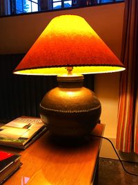 Close-up of illuminated lamp on table at home