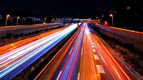 High angle view of light trails on highway at night