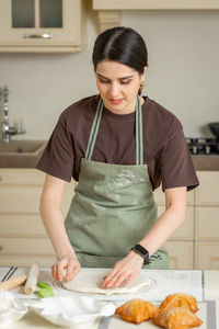 Young woman preparing food at home