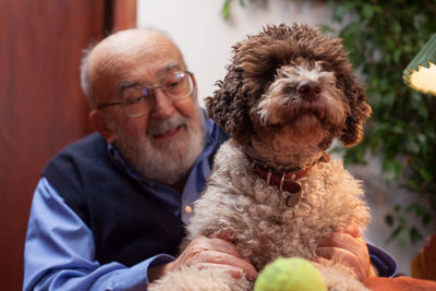 Close-up of man with dog at home