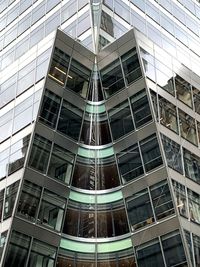 Low angle view of modern glass building in city