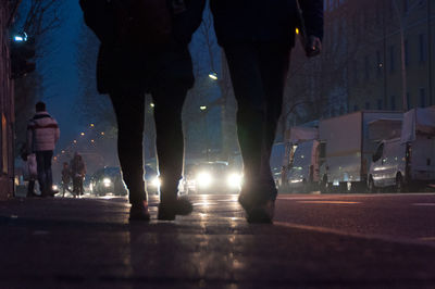 Blurred motion of people walking on road at night