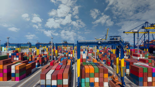 Aerial view commercial dock seaport warehouse and crane ship, container ship at industrial port