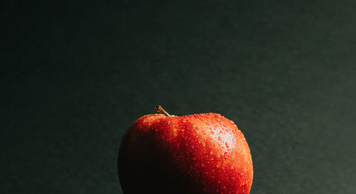 Close-up of apple against black background