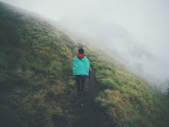 Full length of woman standing on mountain landscape