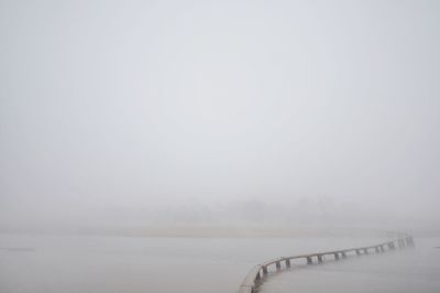 Scenic view of lake against sky during winter