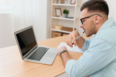 Man using laptop at office