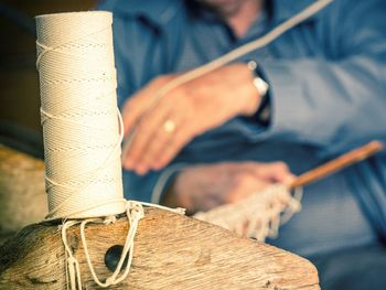 Close-up of thread spool on wood