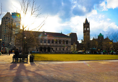 Buildings against cloudy sky