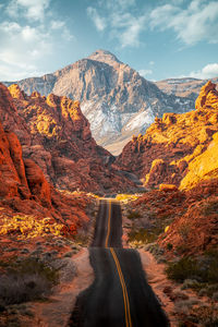 Road amidst rocks against sky