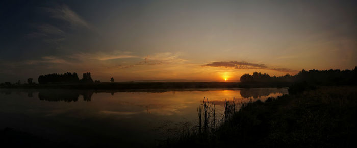 Scenic view of lake against sky during sunset