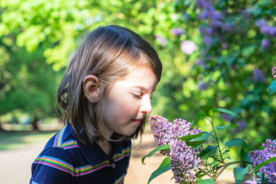 Portrait of woman against pink flowering plants