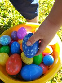 Midsection of girl holding multi colored candies