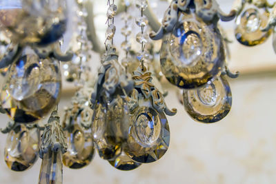 Close-up of chandelier hanging on glass