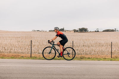 Man riding bicycle on field