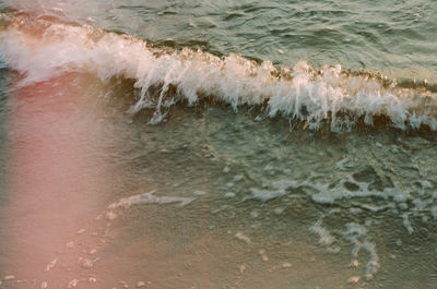 High angle view of waves rushing towards shore