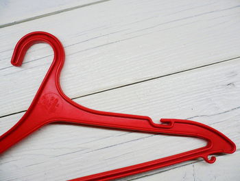 High angle view of red flag on table against white wall