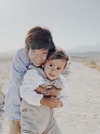 Portrait of two kids hugging in the desert