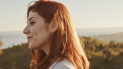 Beautiful girl with white dress explores an ancient italian castle at sunset