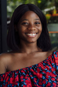 Happy young woman wearing off shoulder top