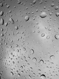 Full frame shot of wet glass window during rainy season