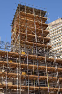 Low angle view of construction site against clear sky