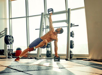 Full length of woman exercising in gym