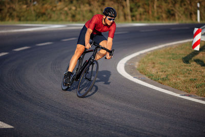 Man riding bicycle on road