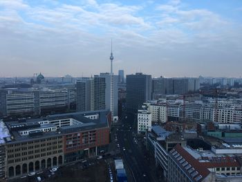 View of cityscape against cloudy sky