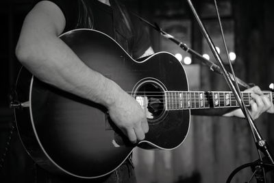 Cropped hand playing guitar