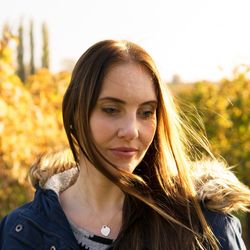 Portrait of smiling young woman against sky