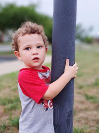 Portrait of boy standing on field