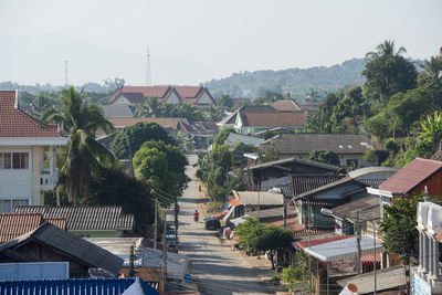 Houses and buildings in town against clear sky