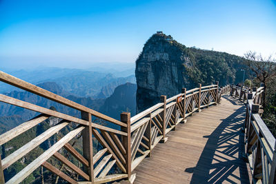 Scenic view of mountains against blue sky