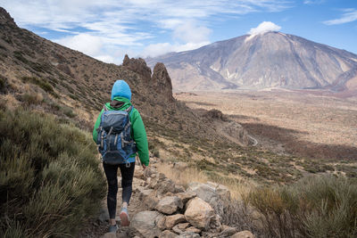 Rear view of man walking on mountain