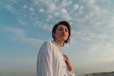 Portrait of woman standing against sky